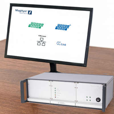 Ein Monitor, der die Maghyst automation zeigt, mit einem Maghyst automation gerät daneben und dessen Anschlussmöglichkeiten wie Profibus, Profinet, CC-Link und Ethernet bei der Ilmenauer Mechatronik GmbH